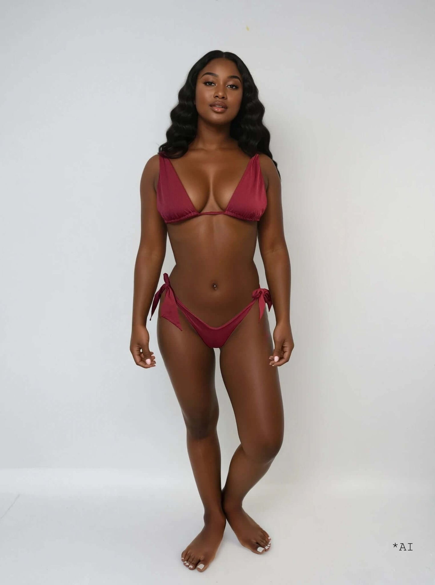 Model wearing Mono Bikini - Bordeaux Red, showcasing elegant triangle top and high-cut bottom with adjustable ties.