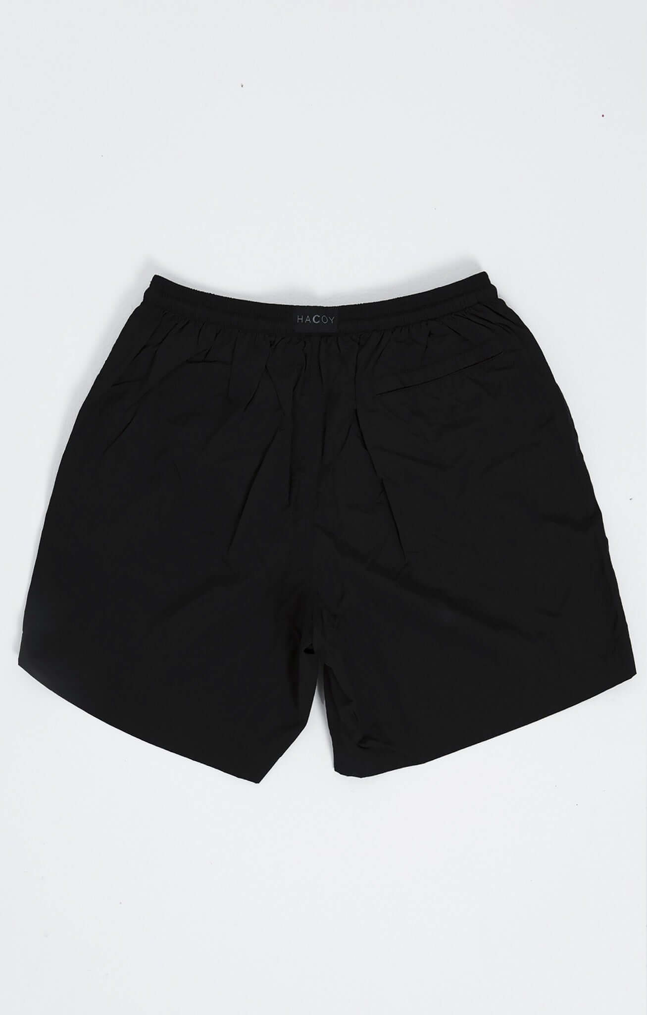 Black swim shorts featuring clean HACOY logo, designed for comfort and style, ideal for poolside and ocean adventures.