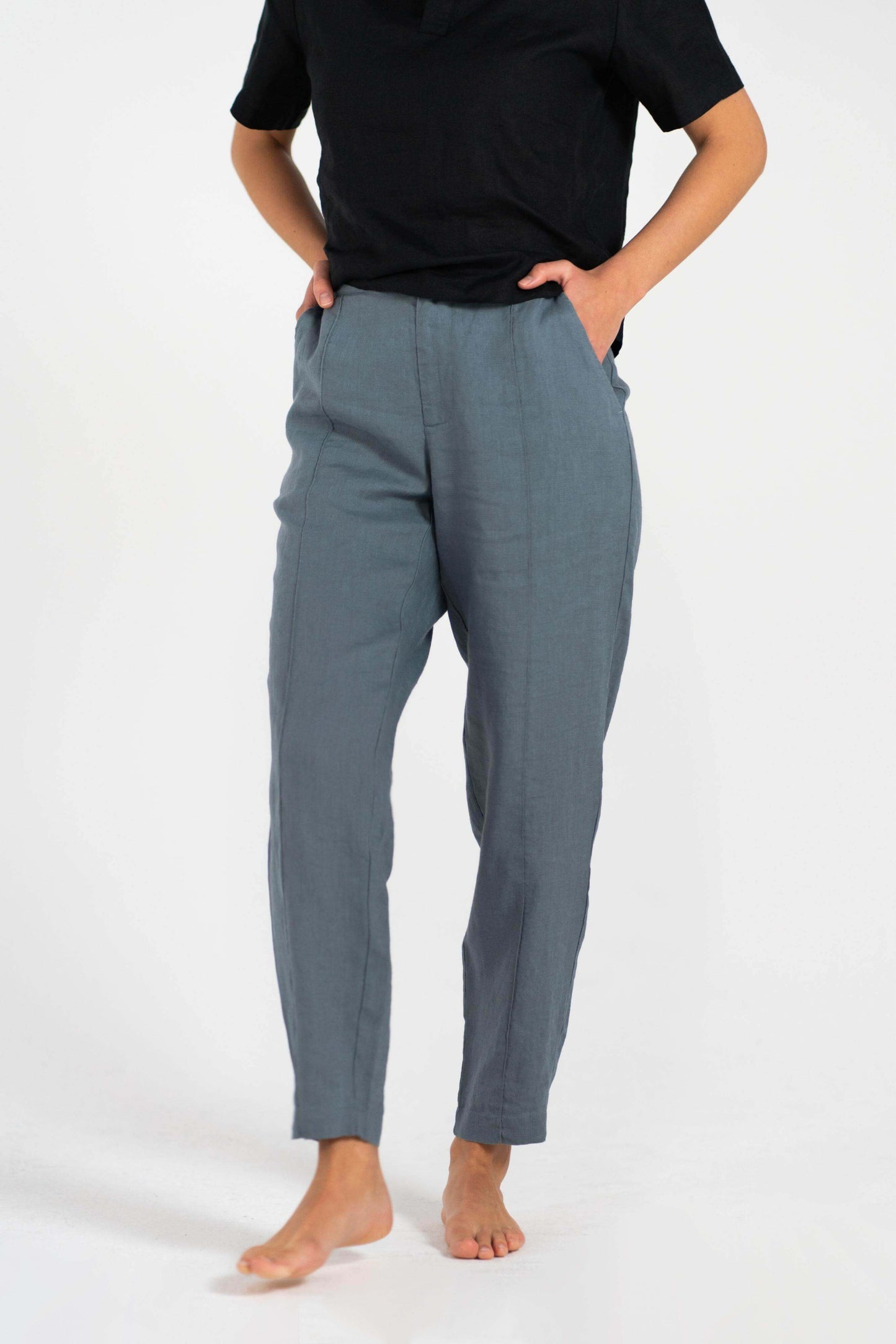 Linen Trousers showcased by model standing with hands in pockets, embodying comfort and elegance.