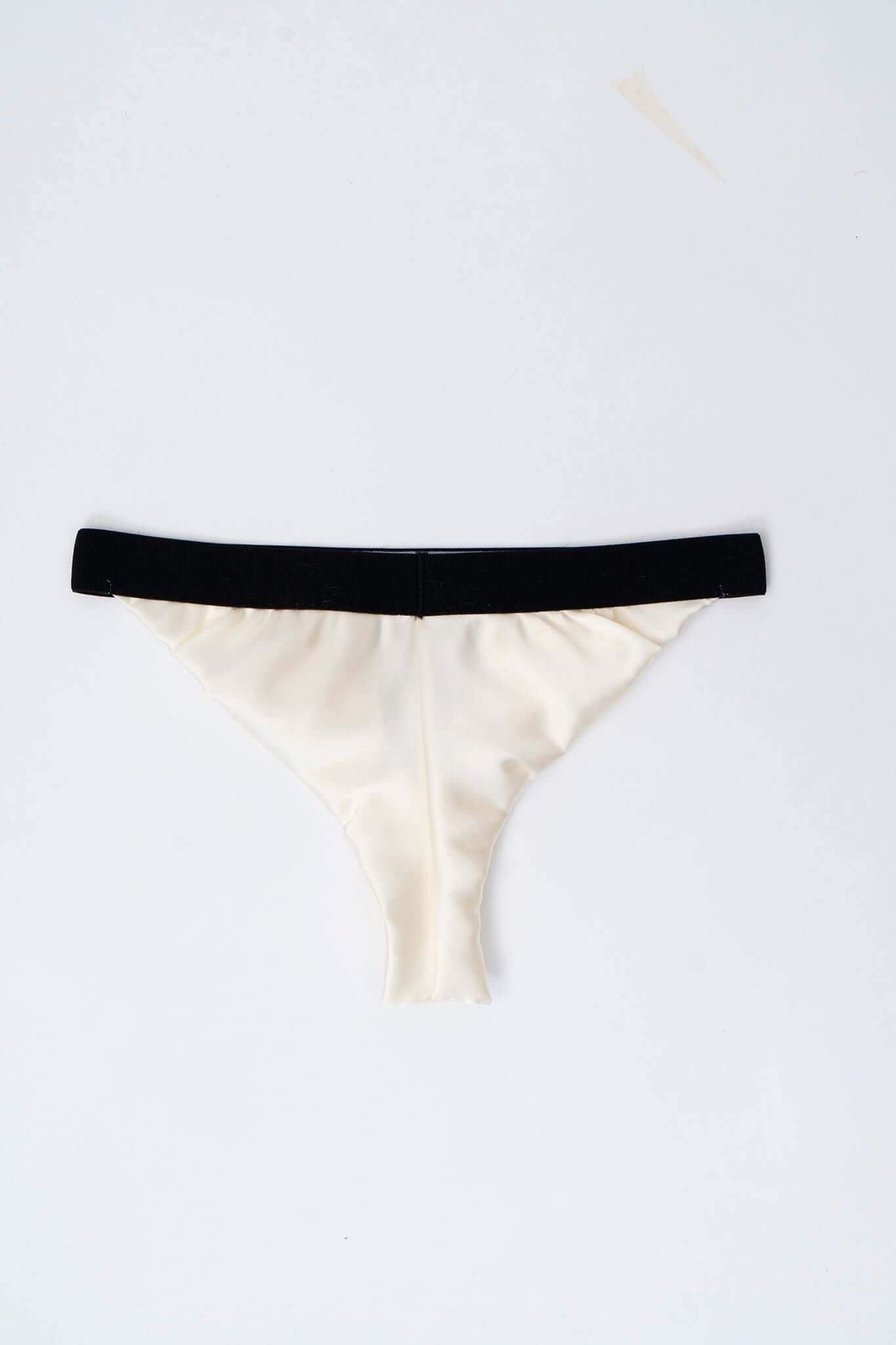 Luxury Silk Slip HACOY | Comfortable Elegance. Stylish ivory silk thong with black waistband, embodying comfort and elegance.