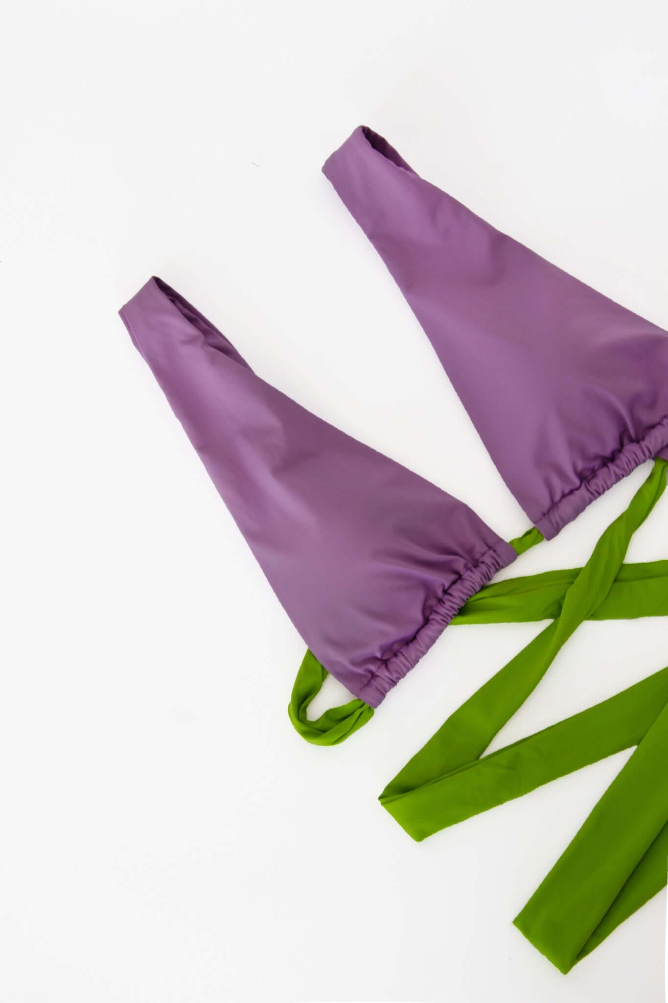 Dual Bikini top in purple and green with adjustable ties, perfect for a stylish beach look.