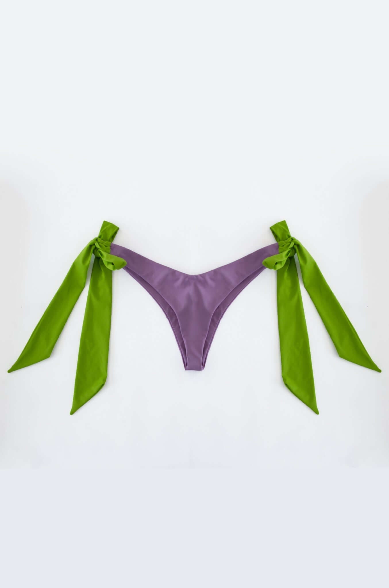 Dual Bikini high cut bottom in purple and green with hardware-tipped ties on the sides.