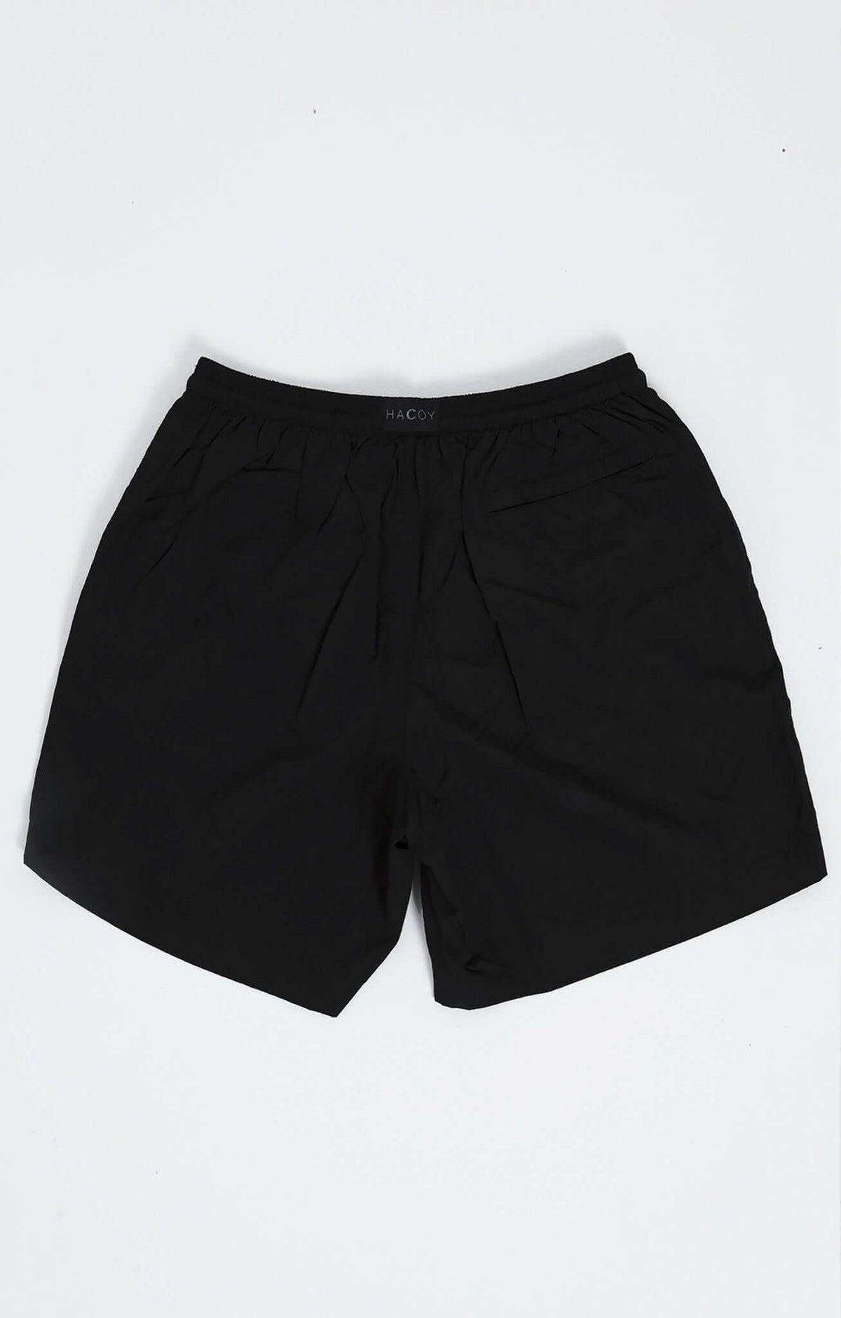 Black swim shorts featuring clean HACOY logo, designed for comfort and style, ideal for poolside and ocean adventures.