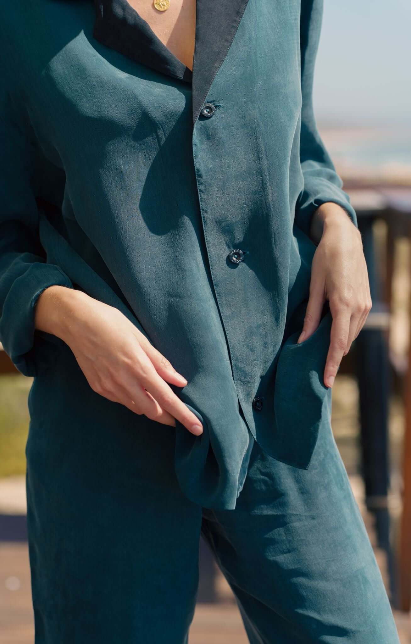 Model wearing a dark green Pyjama Set with a stylish design and vegan, sustainable Cupro fabric.