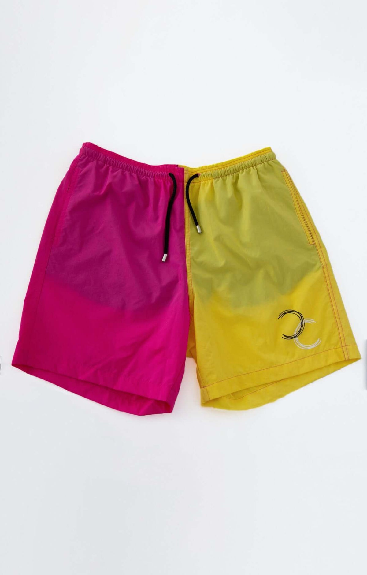 Dual Swim Shorts in vibrant pink and yellow with drawstring closure and monogram detail.