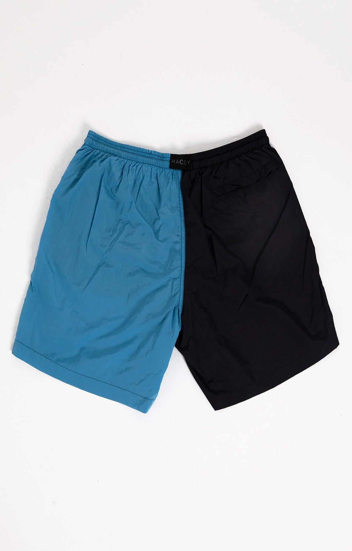 Dual Swim Shorts in navy and light blue, featuring a drawstring closure and brand monogram.