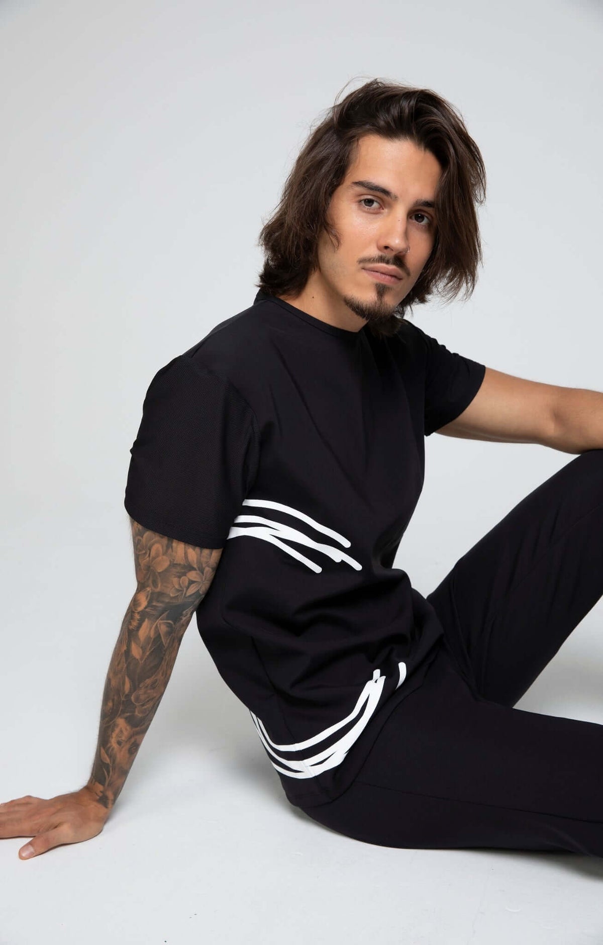 Sports Shirt in black with unique design and fitted silhouette, ideal for exercise and active wear.