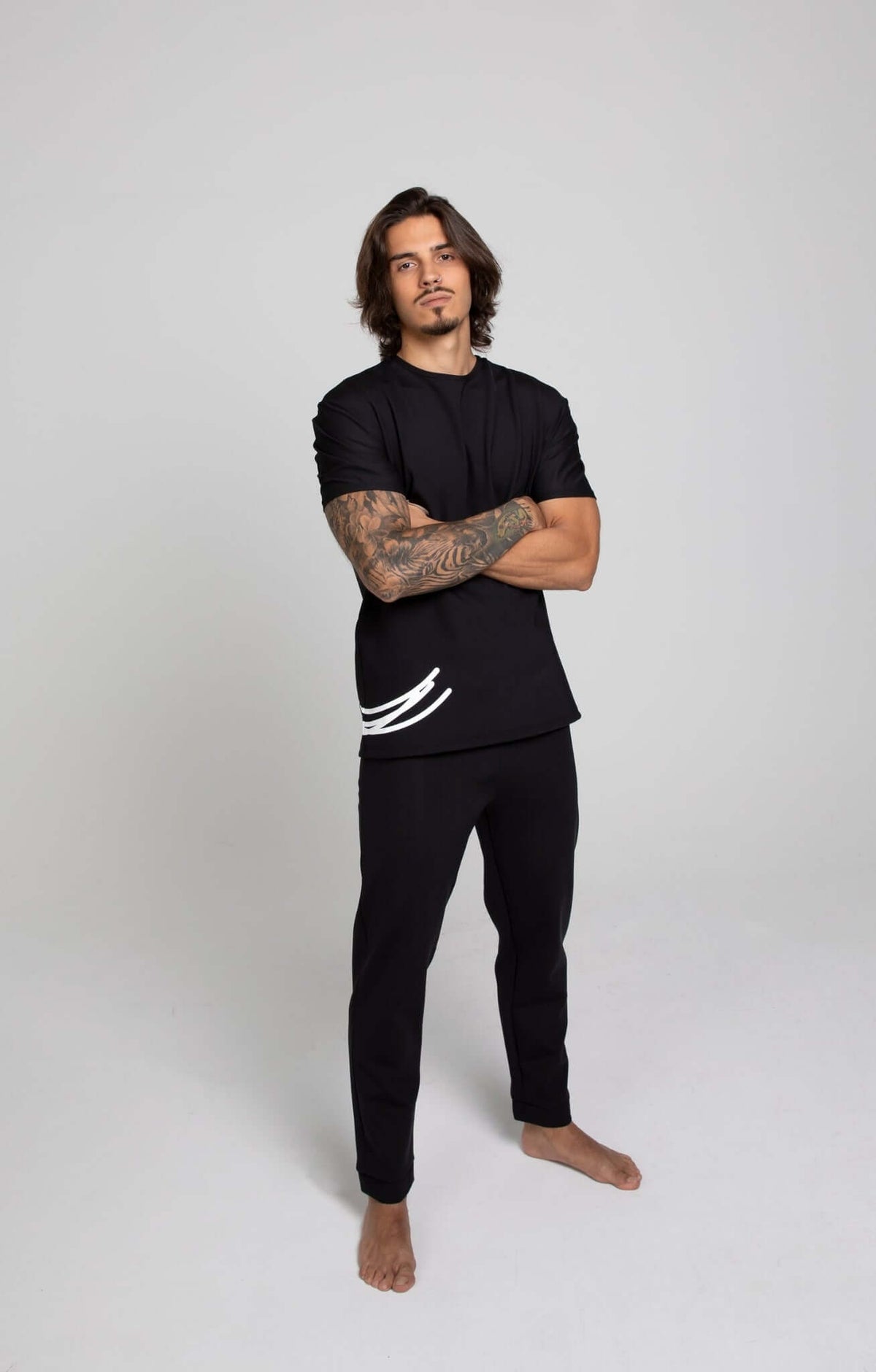 Man wearing black sports pants optimized for comfort and style during exercise.