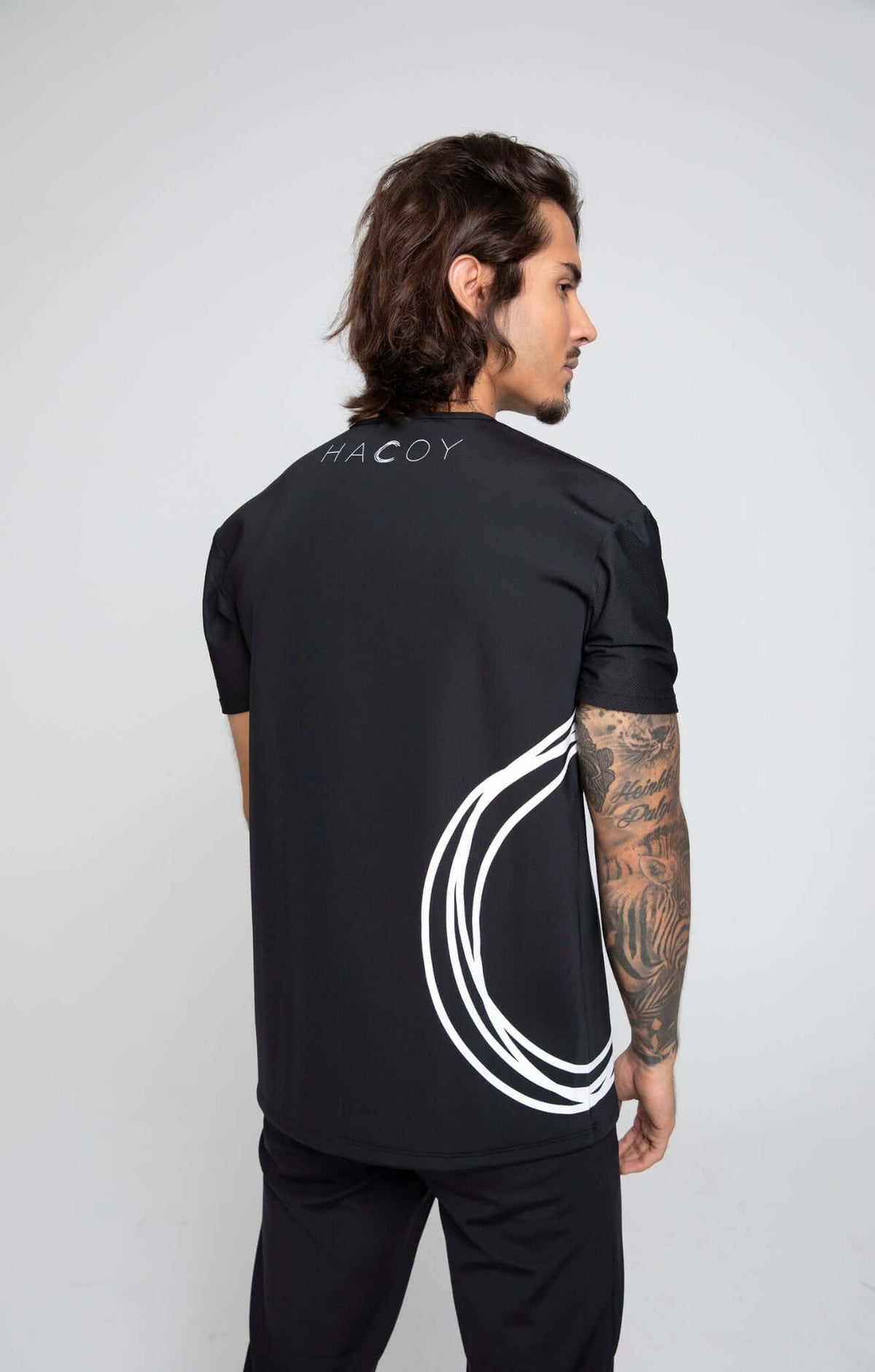 Sports Shirt featuring a unique design with the brand's monogram and artistic lines on the back.