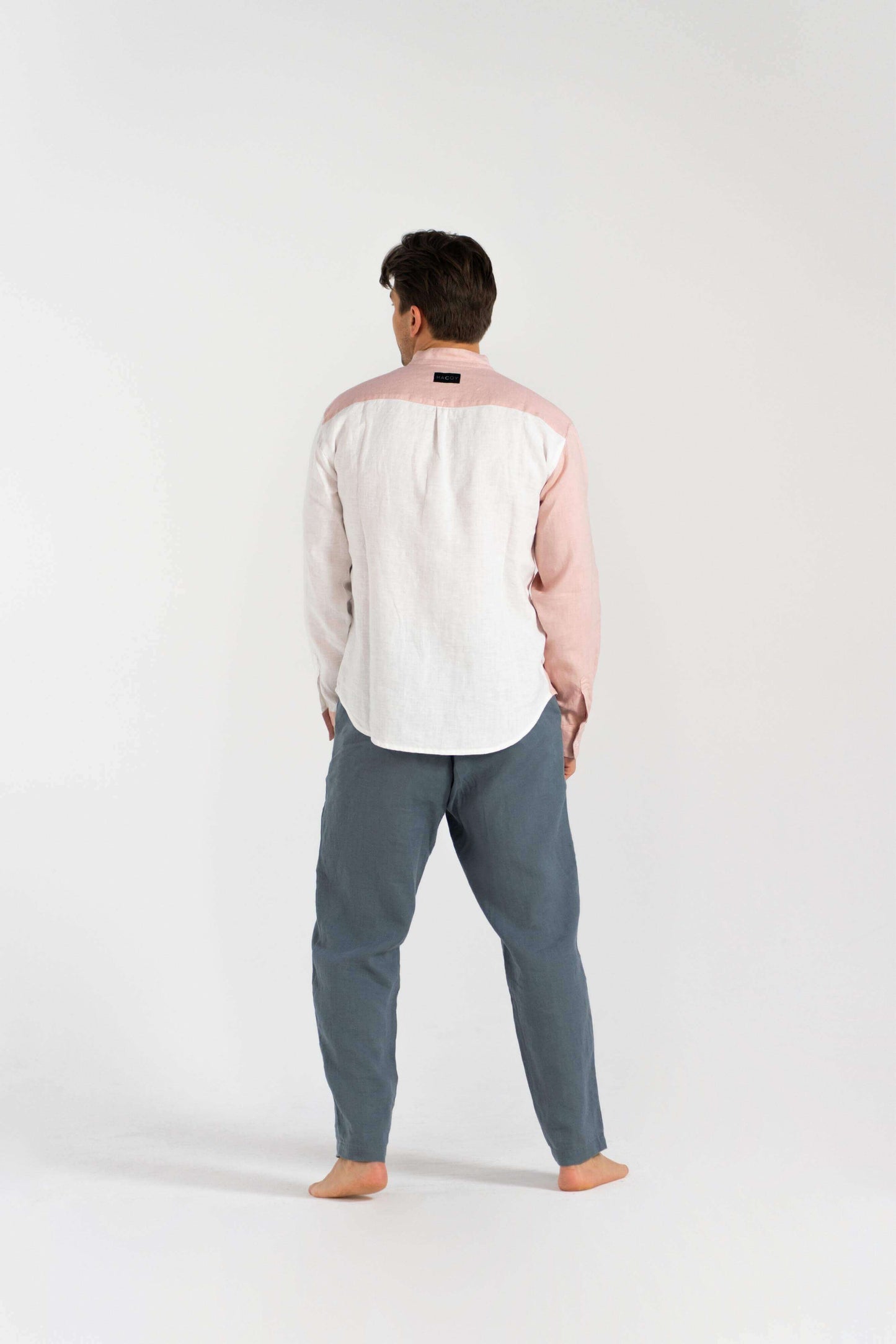 Model wearing Linen Dual Shirt (Pre-owned) from the back, with minimalist style and sustainable design.